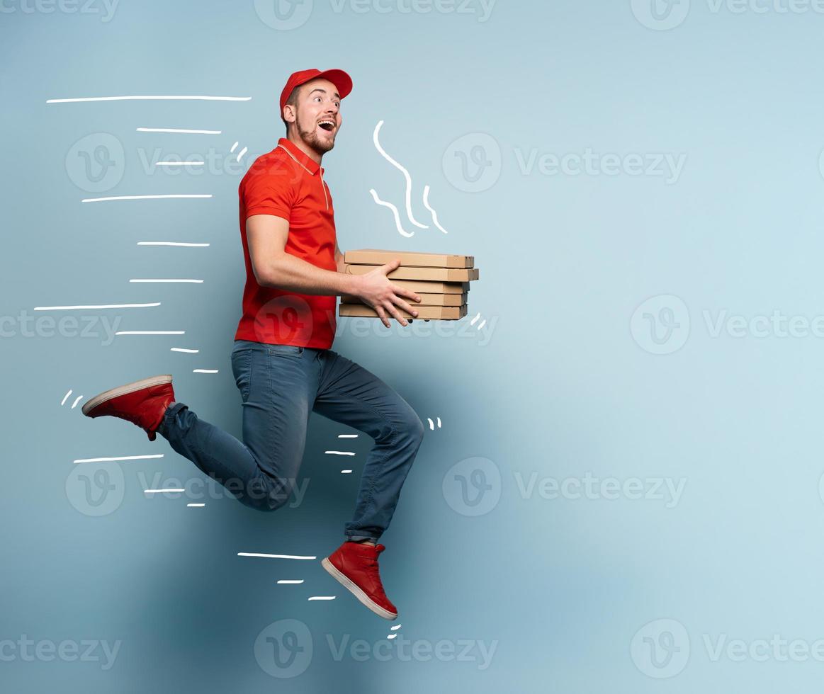 Courier runs fast to deliver quickly pizzas. Cyan background photo