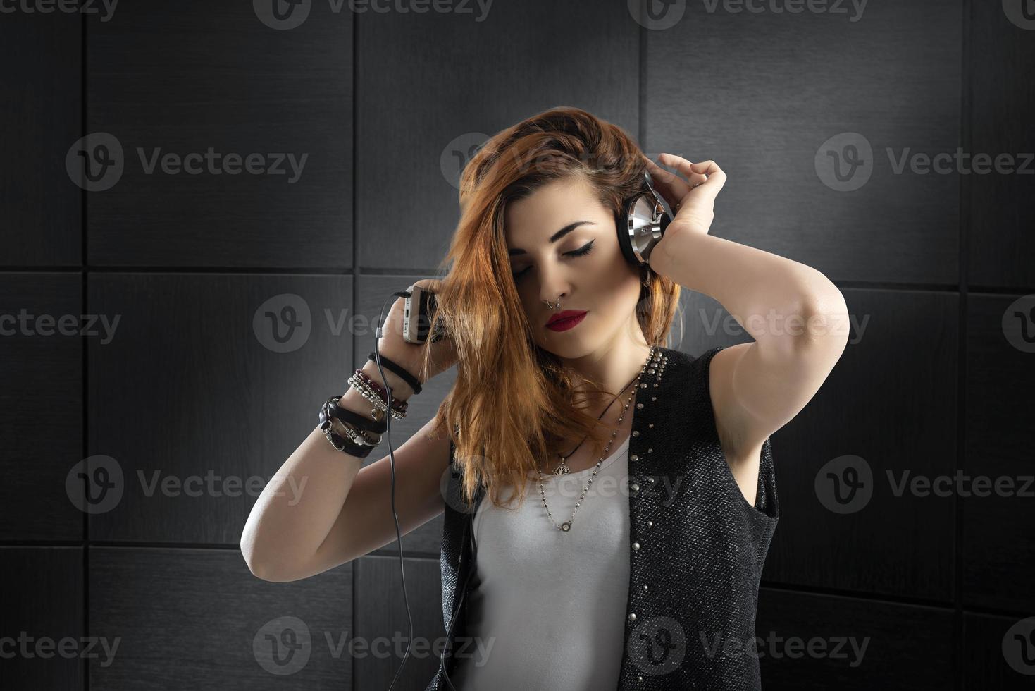 Dancing girl listens to music with headset photo