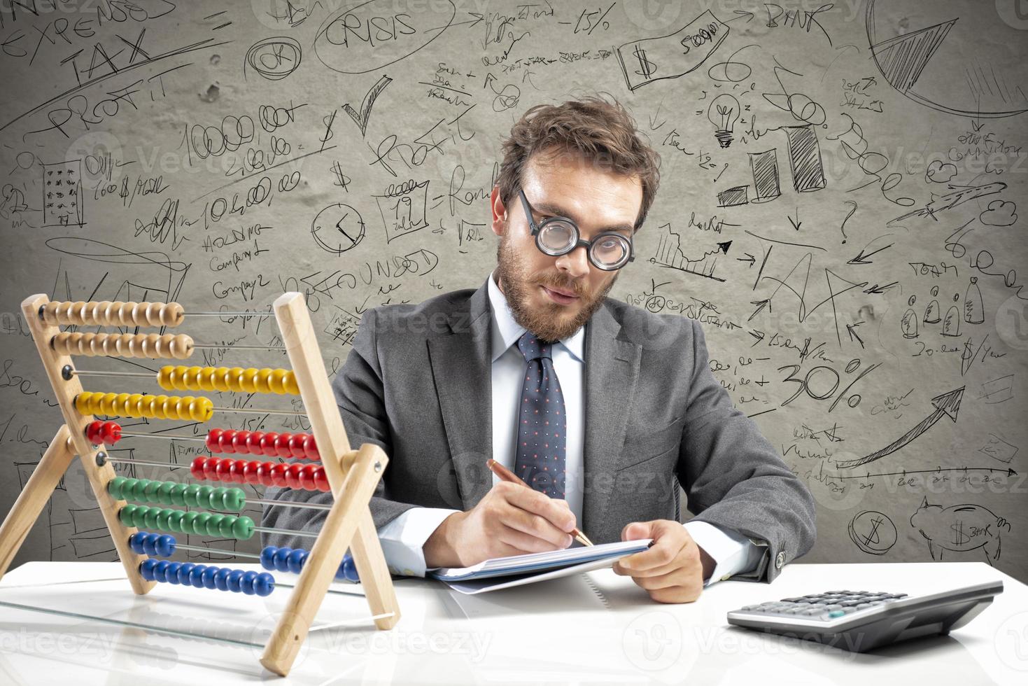 Nerd accountant does calculation of company revenue photo