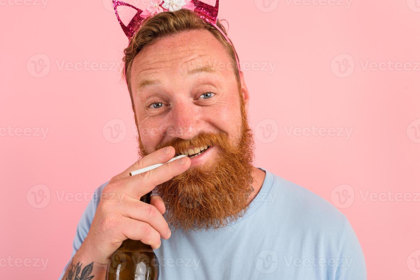 Happy man with beard and tattoos acts like a princess of a tale photo