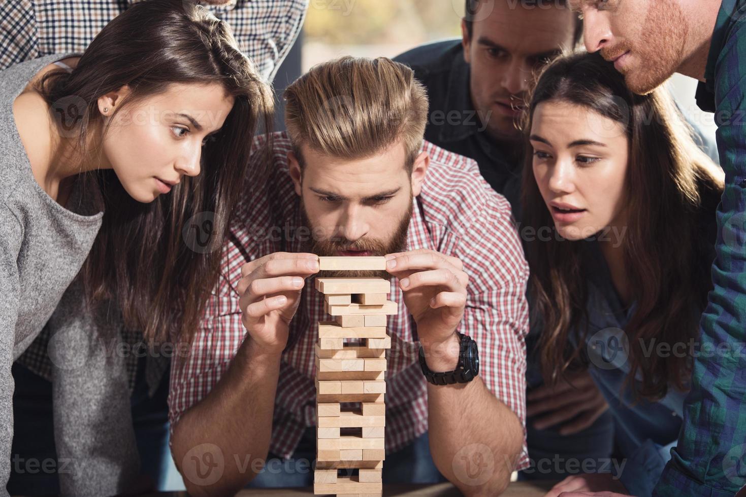 Team of business people build a wooden construction. concept of teamwork ,partnership and company startup photo