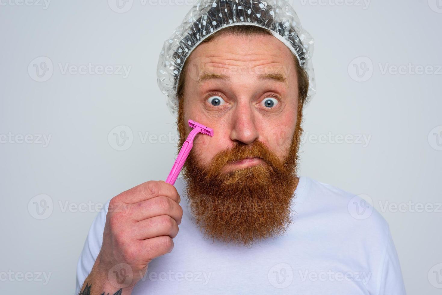 Man adjust the beard with a razor blade photo