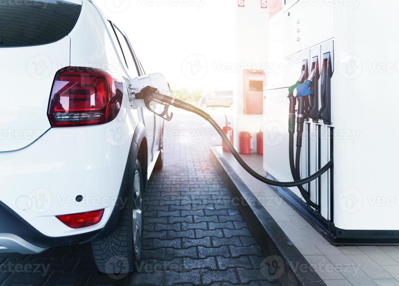 Fuel pump fill a tank of a car in a station photo