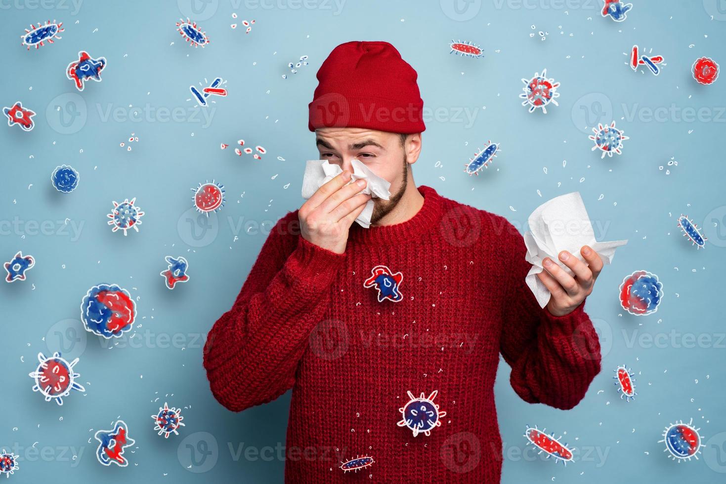 Boy caught a cold and is surrounded by viruses and bacteria. Studio on Cyan background photo