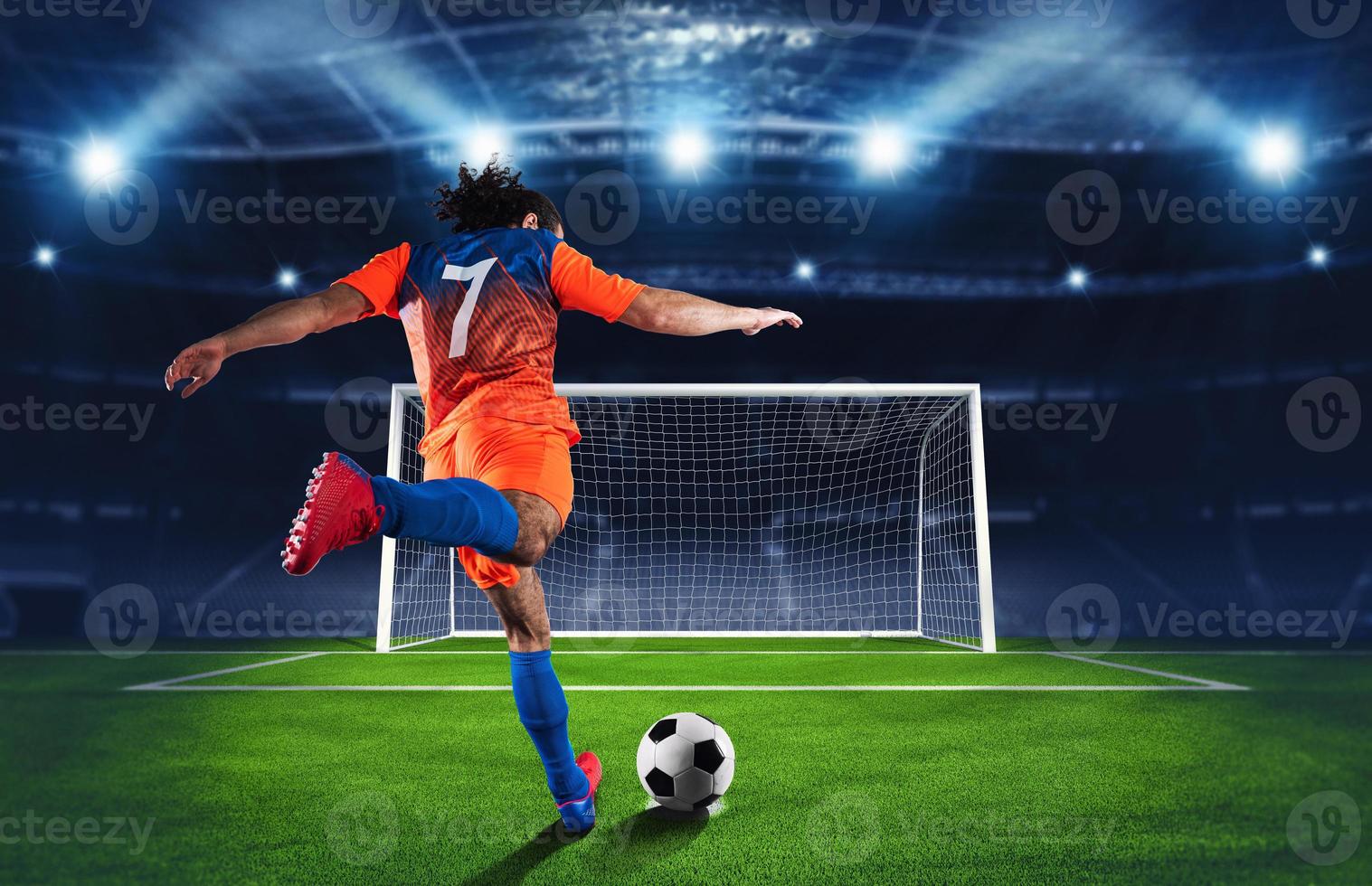 Soccer scene at night match with player in an orange and blue uniform kicking the penalty kick photo