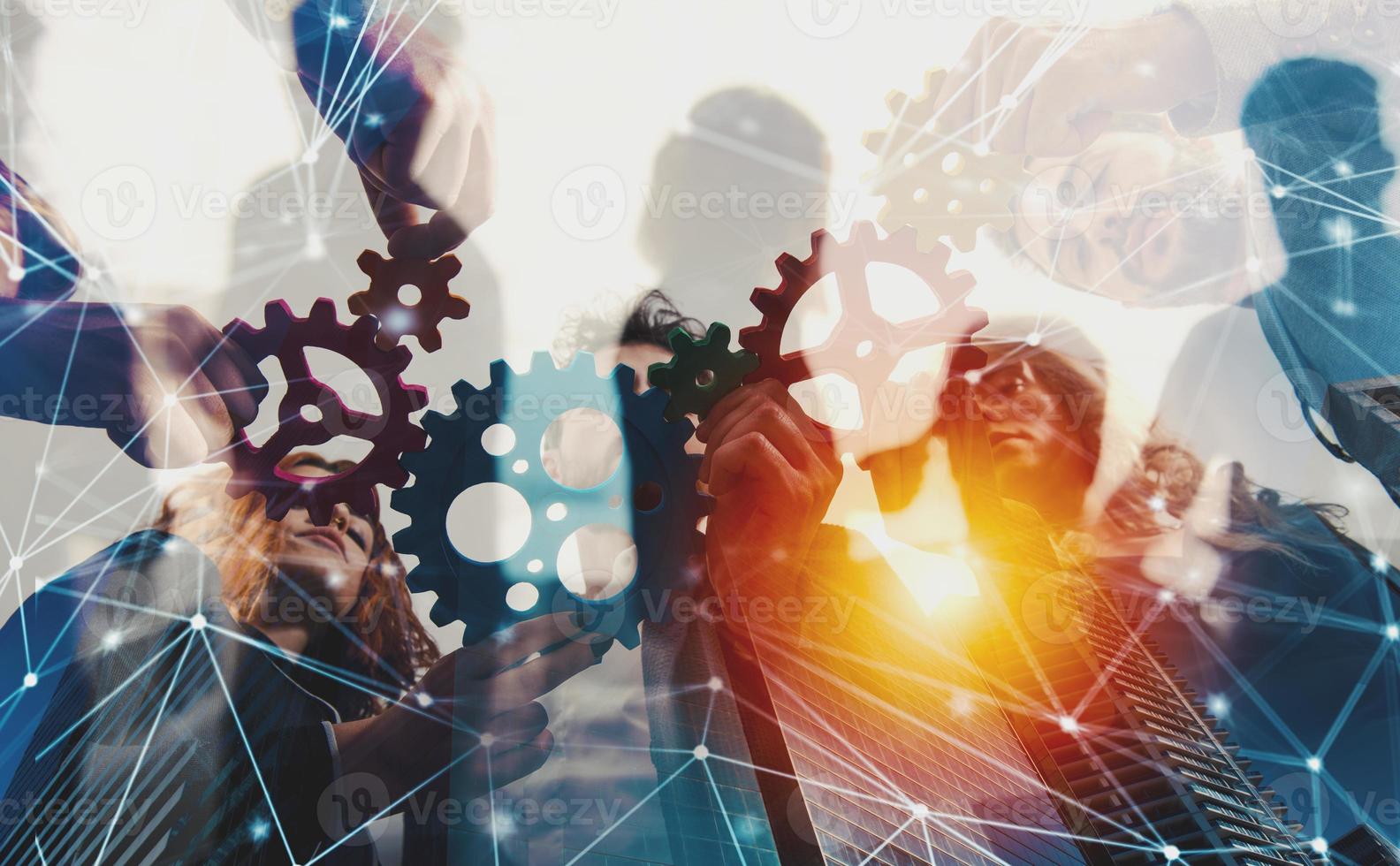 Business team connect pieces of gears. Teamwork, partnership and integration concept with network effect. double exposure photo