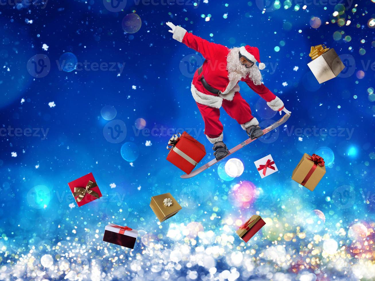 Santa claus jumps with a snowboard board photo