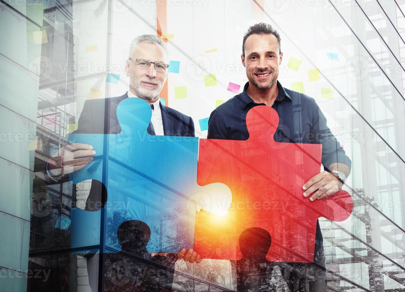 Partnership of business people. Concept of integration and startup with colored puzzle pieces photo