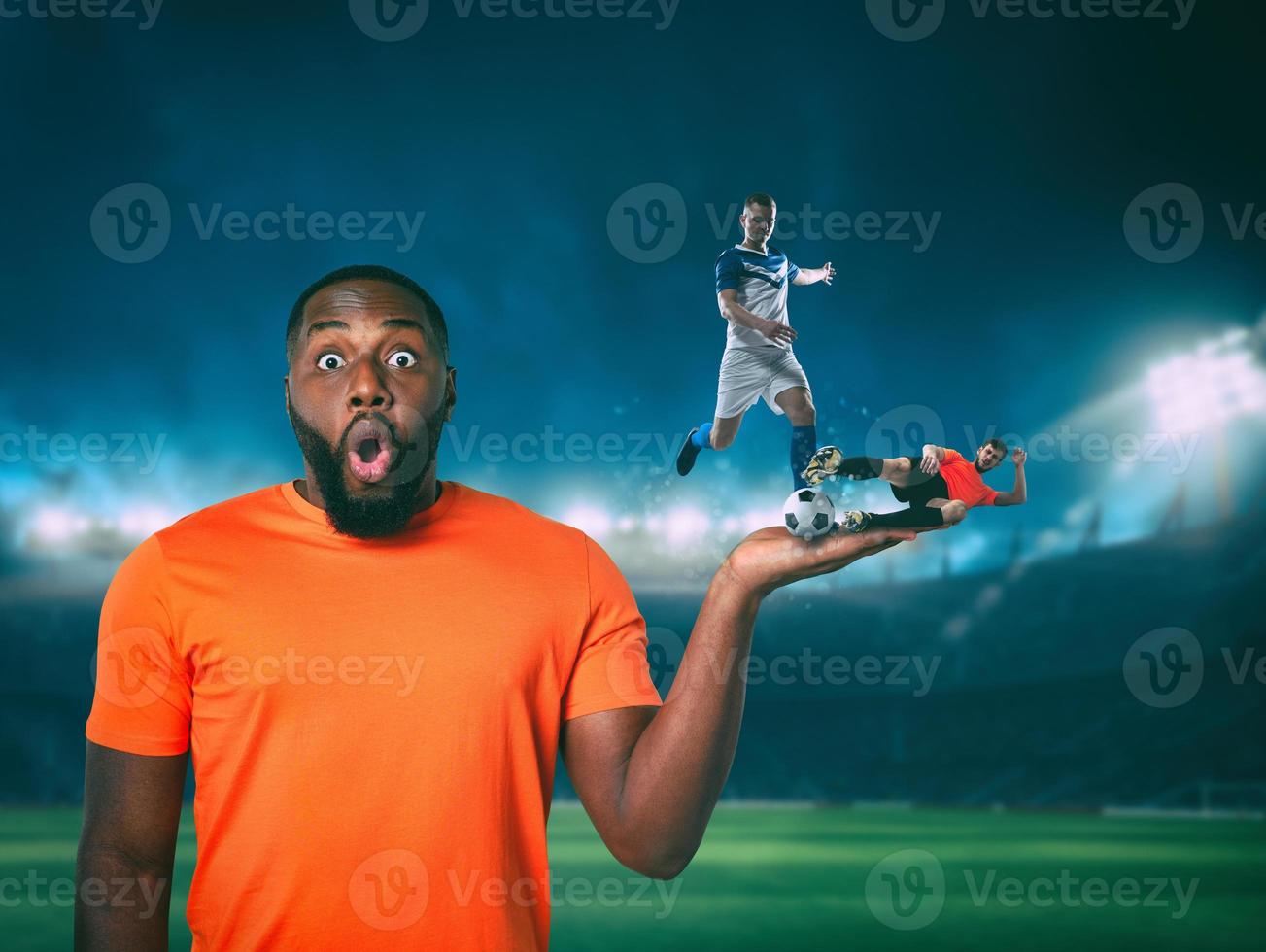 Soccer players compete for the ball on the hand of an astonished fan photo