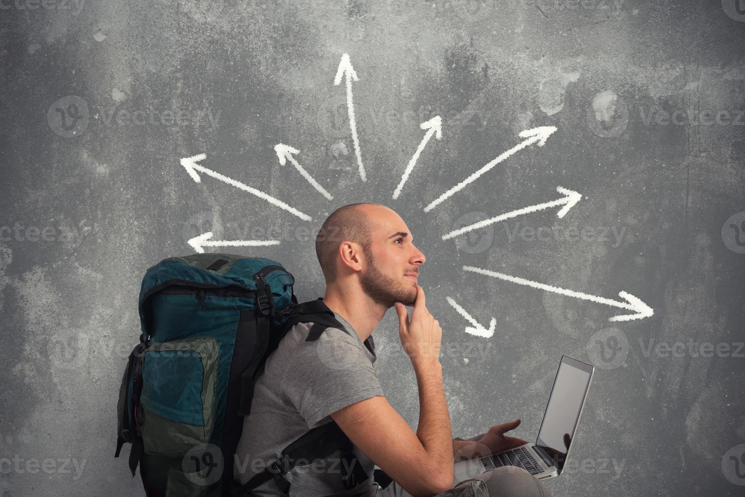Explorer plans a new travel with his laptop photo