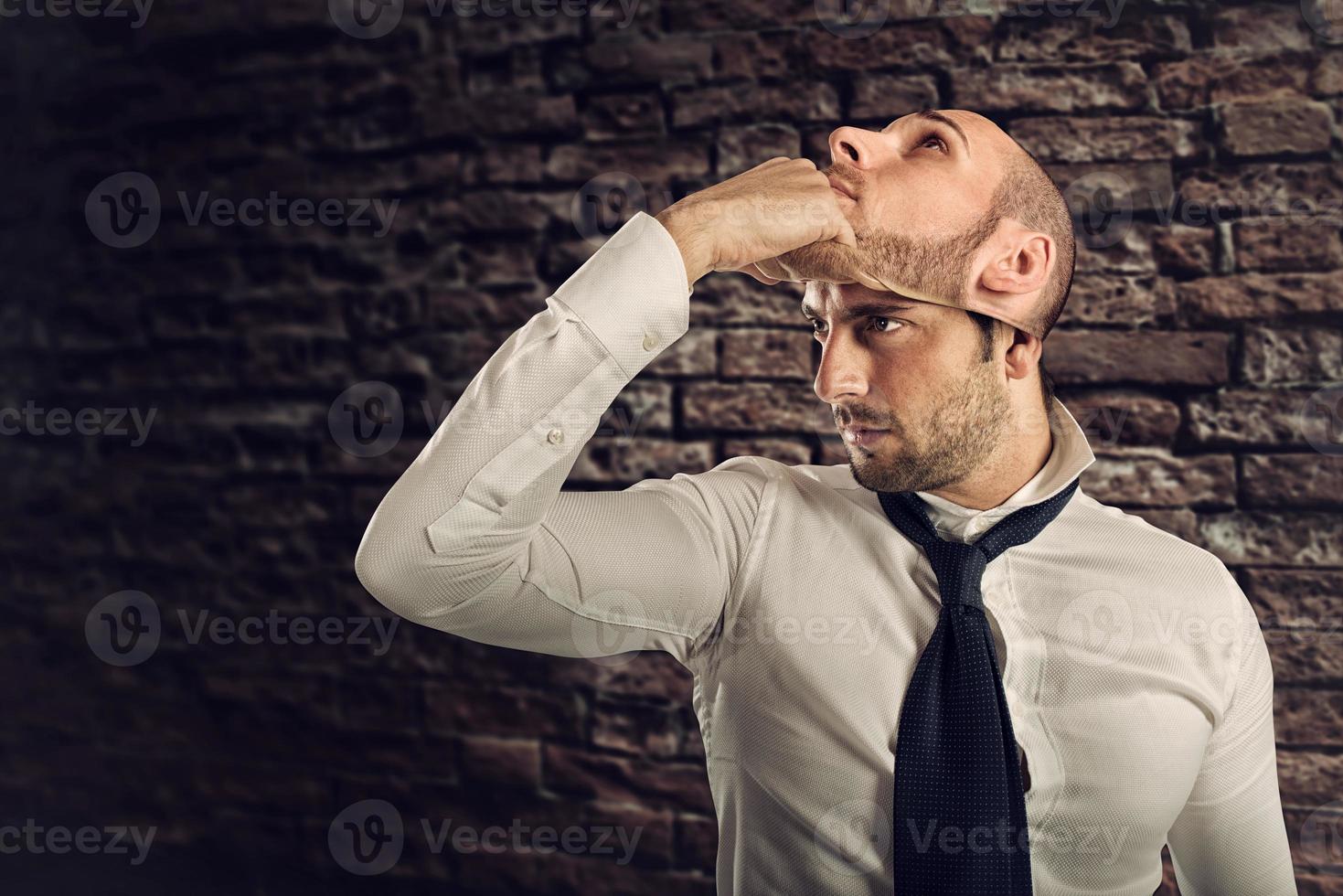 Businessman with multiple personality changes the mask photo