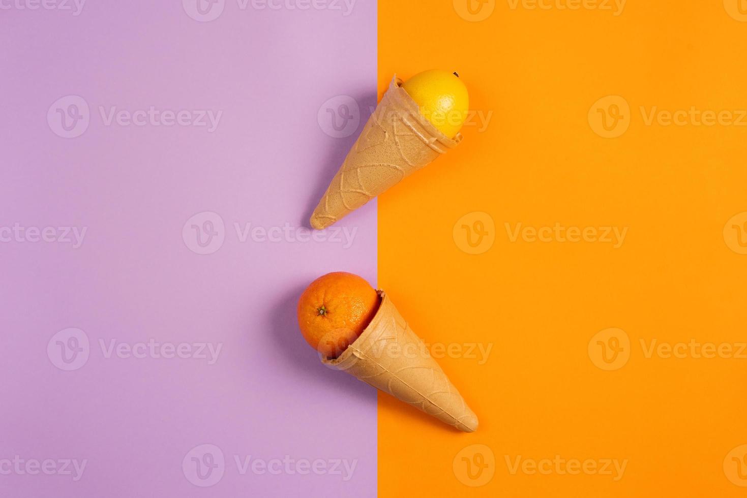 Ice cream with natural orange and lemon fruits. Concept of genuine and biologic fruit. Purple and yellow background photo