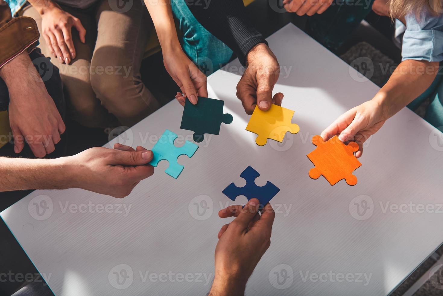 Teamwork of partners connect puzzle pieces as integration and startup photo