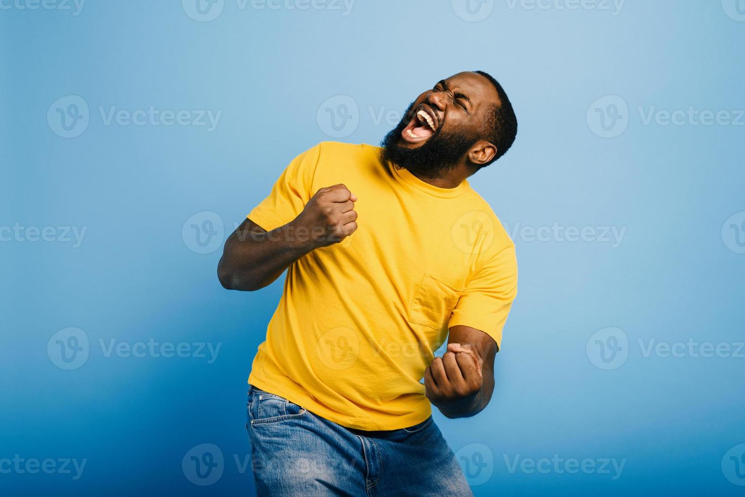 Boy wins something. Amazed and surprised expression face. Light blue background photo