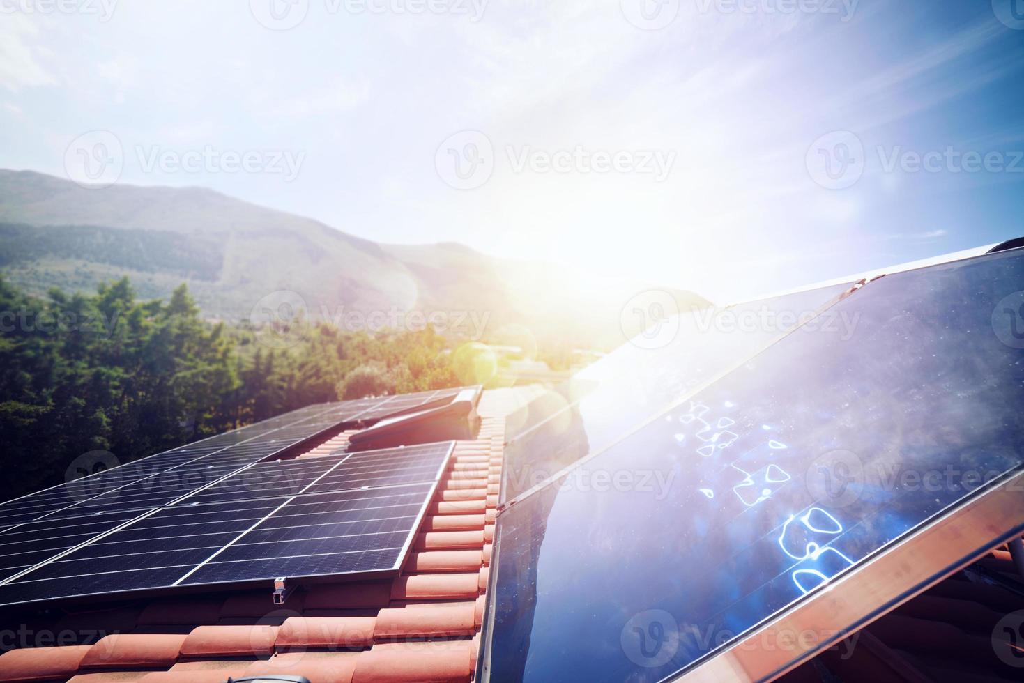 Renewable energy system with solar panel for electricity and hot water photo