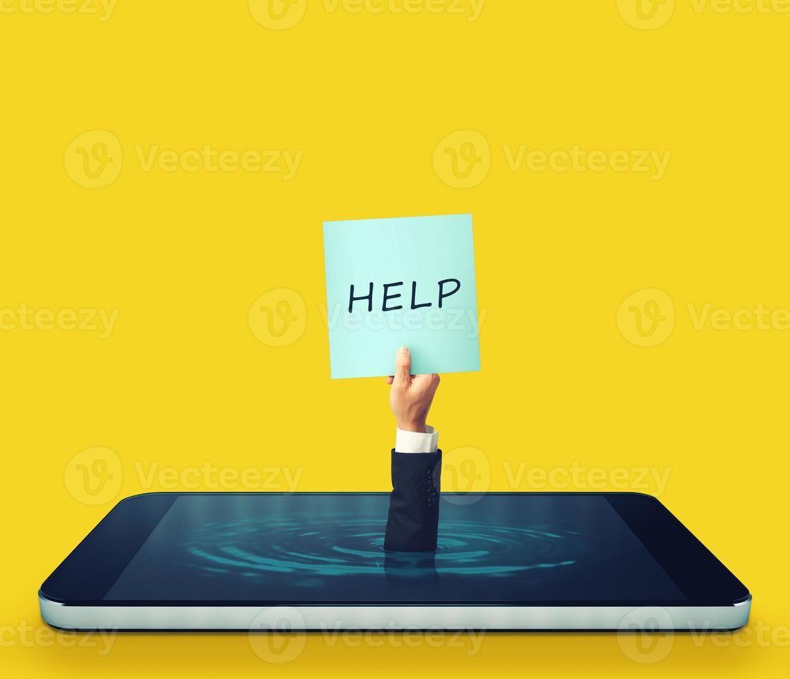Man is sinking into a smartphone display and asking for help with a sign photo