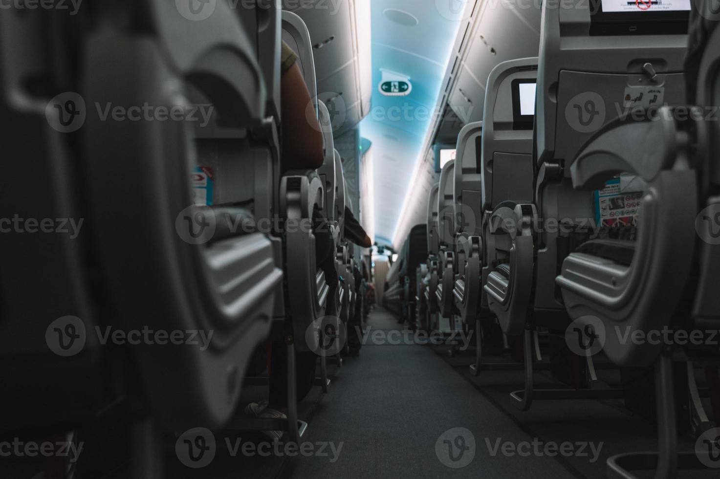 Aircraft interior with aisle and airplane seats photo