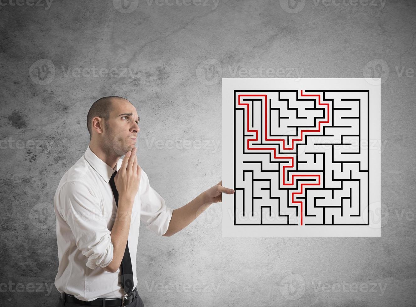 Businessman with solutions of maze photo
