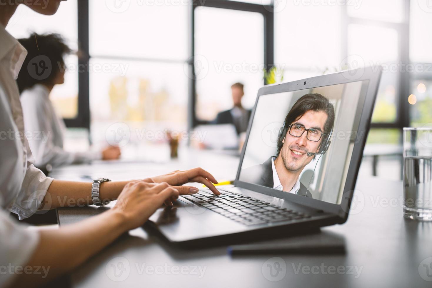 Businessman is working in remote with a videocall due to quarantine of coronavirus covid19. Concept of smart working photo