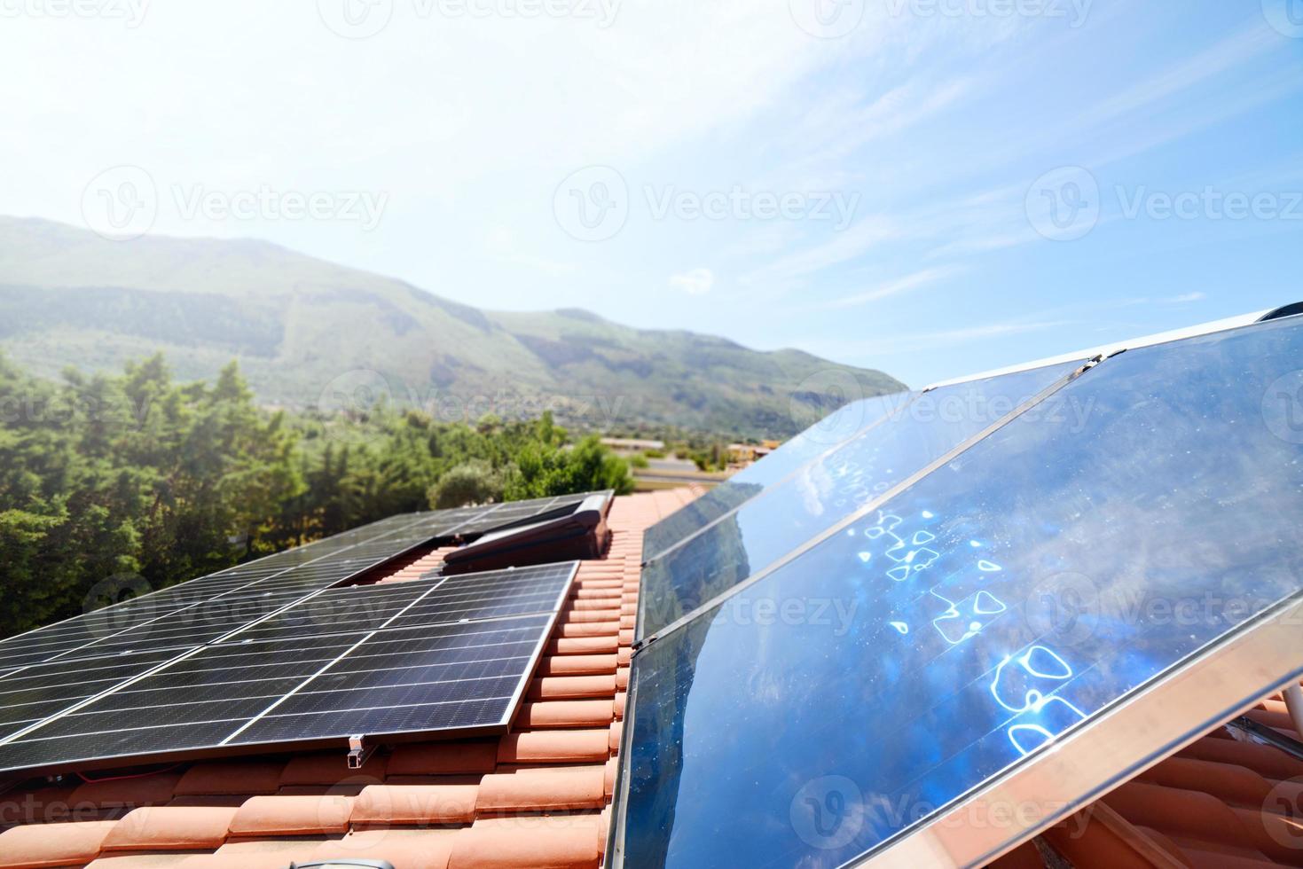 Renewable energy system with solar panel for electricity and hot water photo