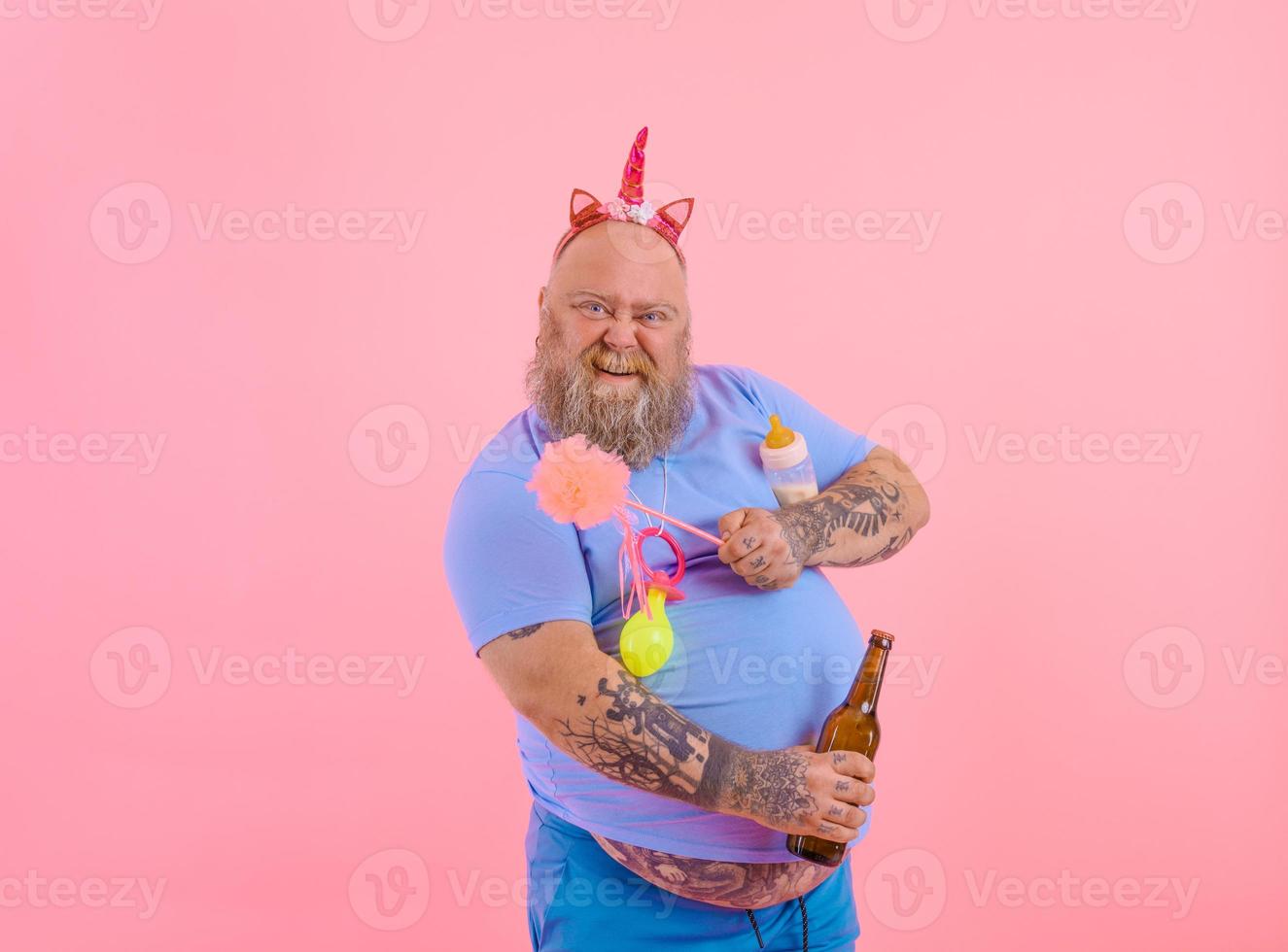 Fat happy man acts like a happy baby but drinks beer photo
