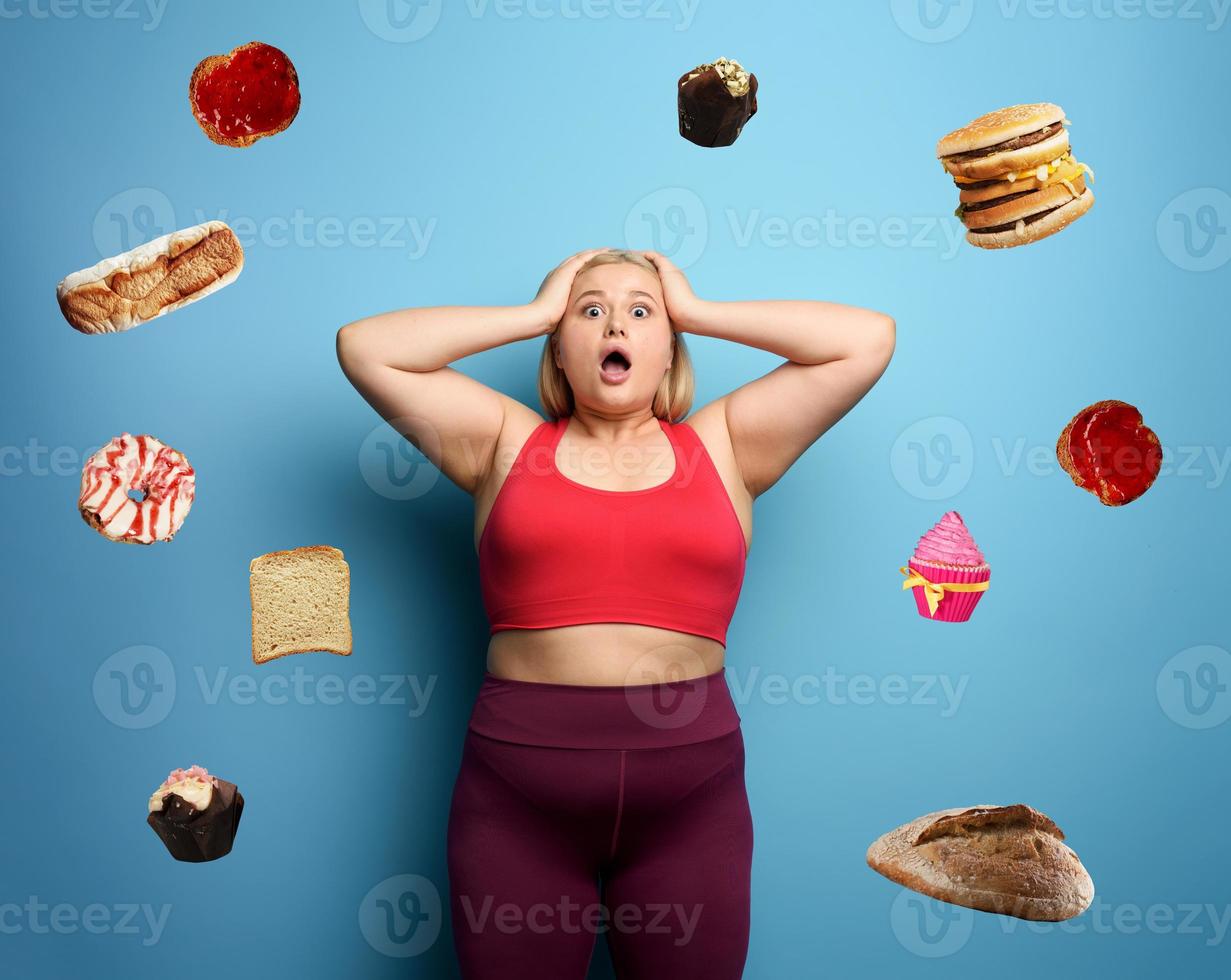 Fat girl in fitness suite wants to start a diet but has doubts about