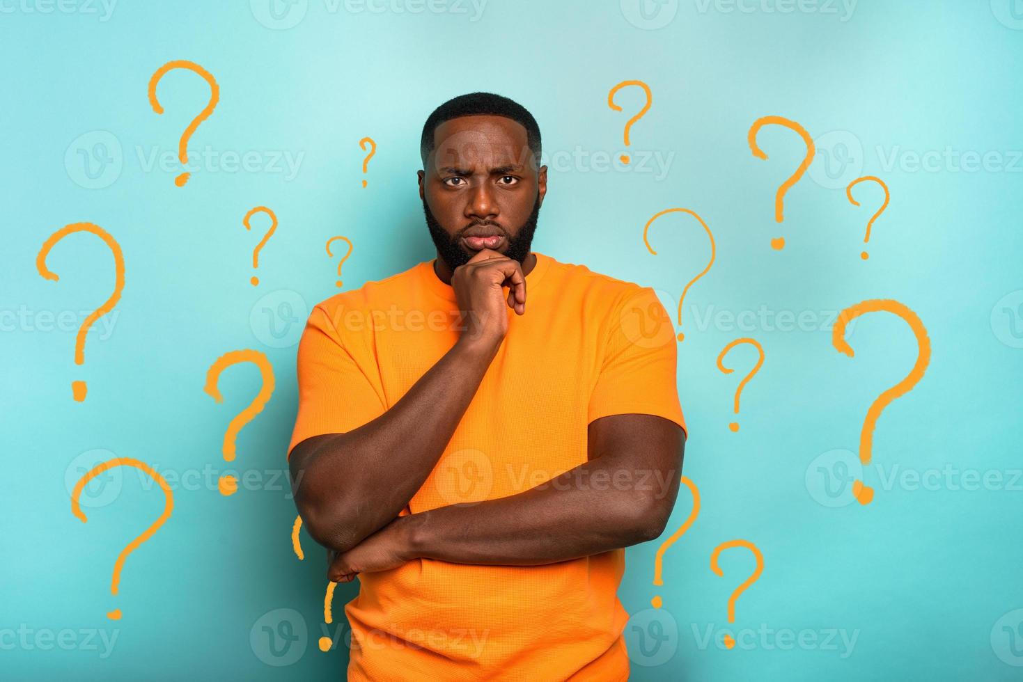 Confused man thinks something and has a doubtful expression photo