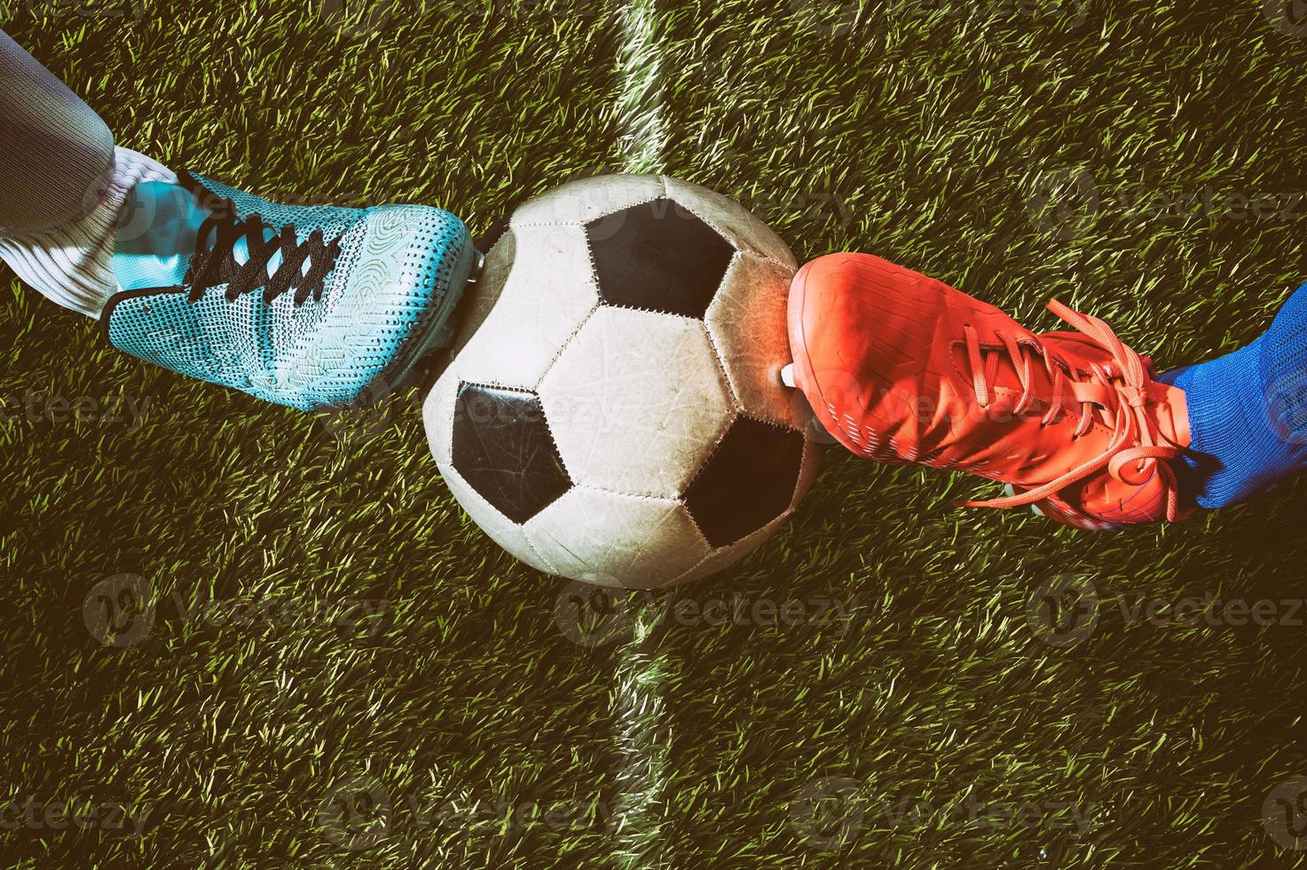 Two soccer players challenge each other at the stadium photo