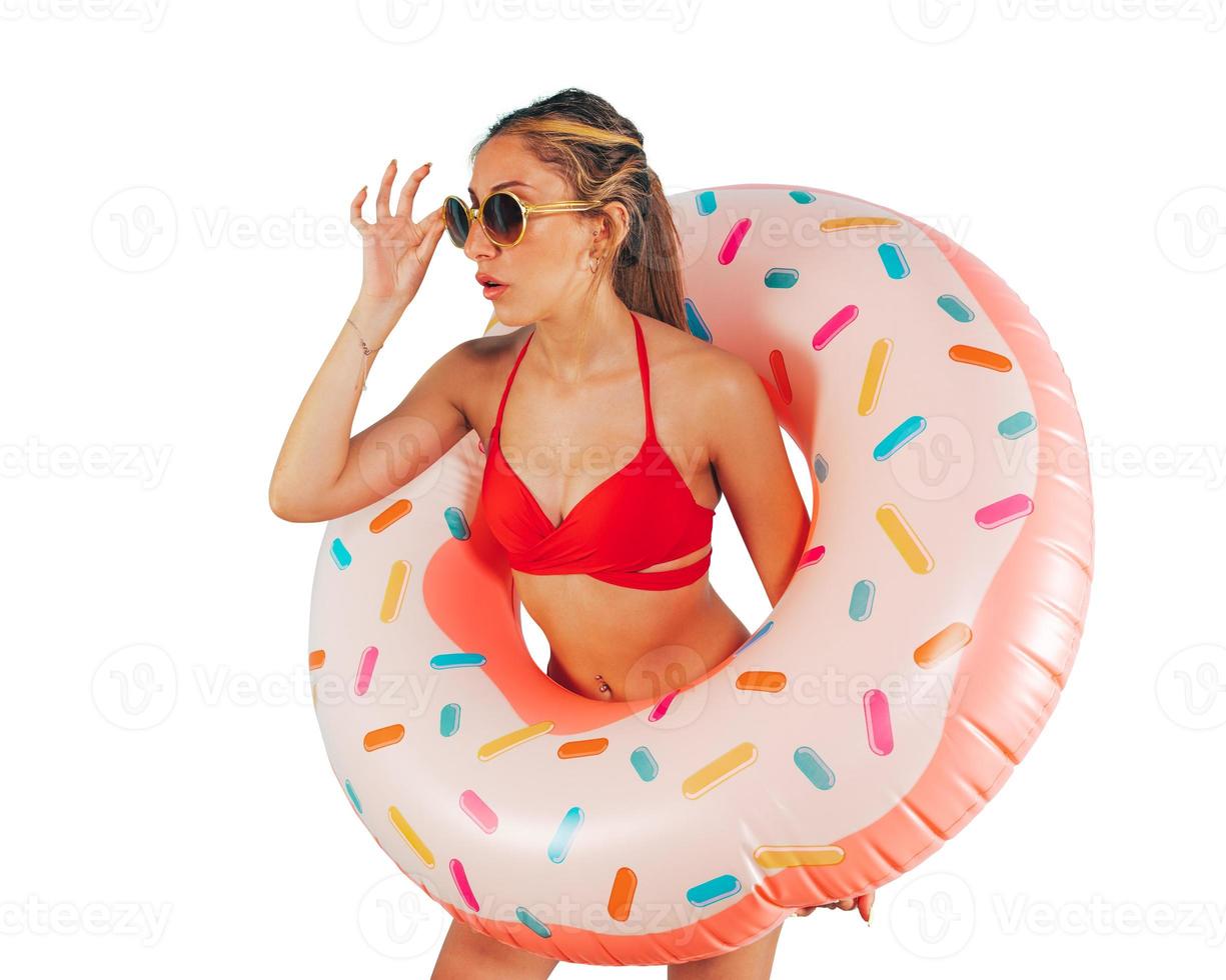 Amazed woman exits from an inflatable donut photo