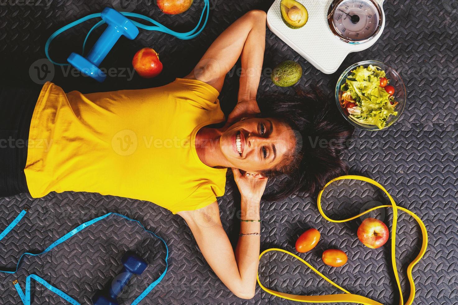 Happy woman does exercises with elastic at the gym photo