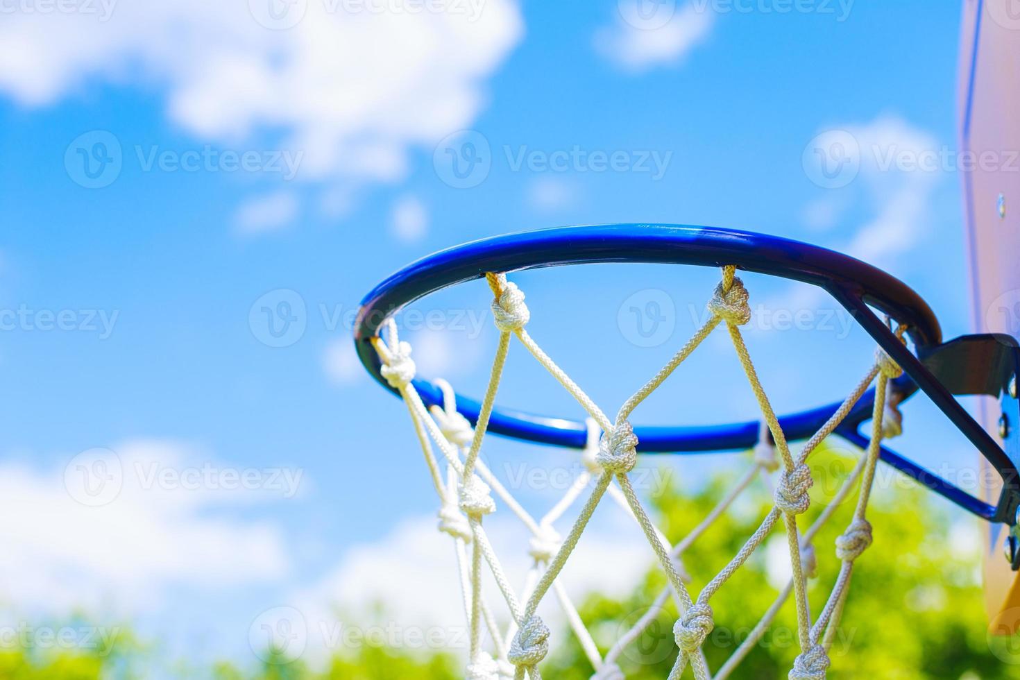 Basketball ring on blue sky background photo