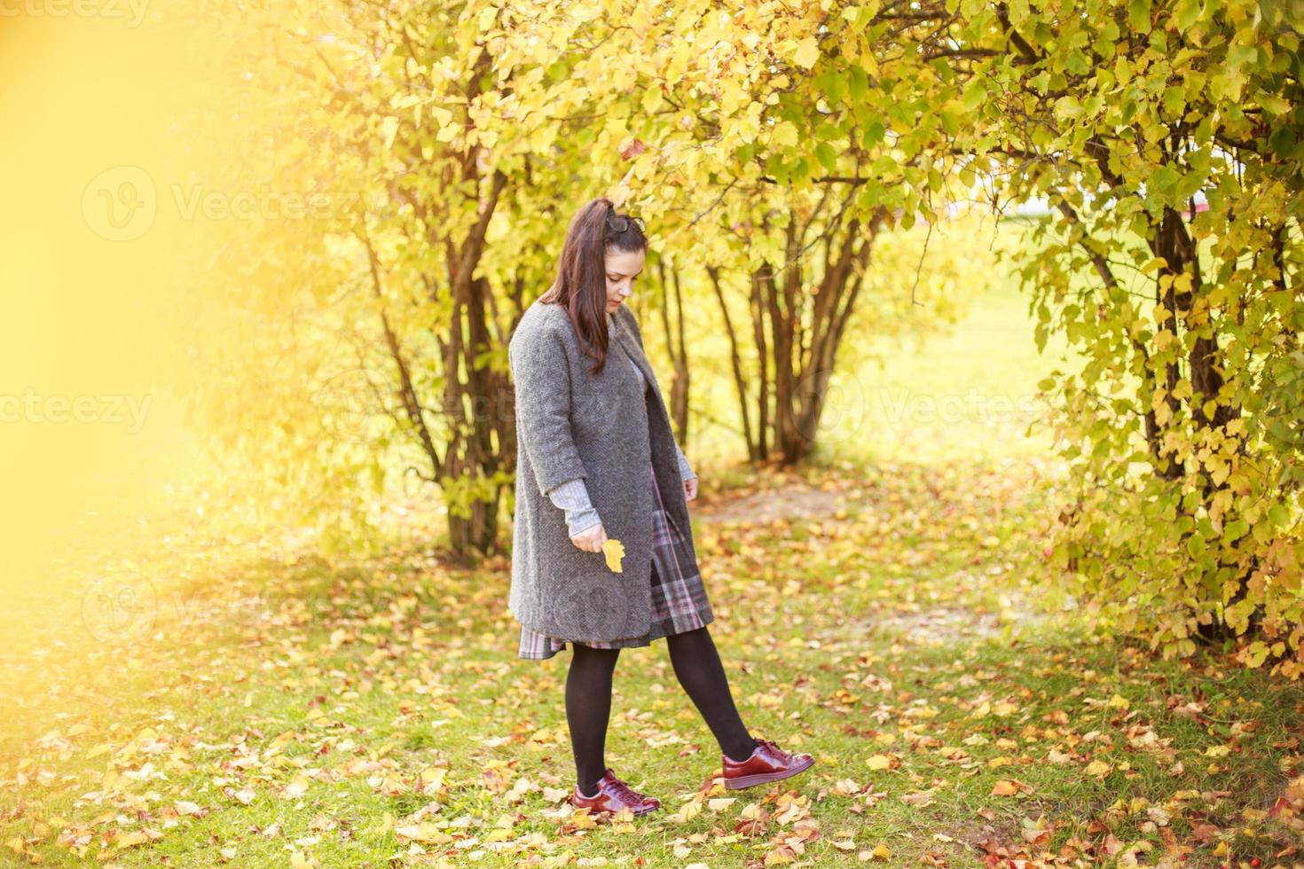 girl walks in the autumn park photo