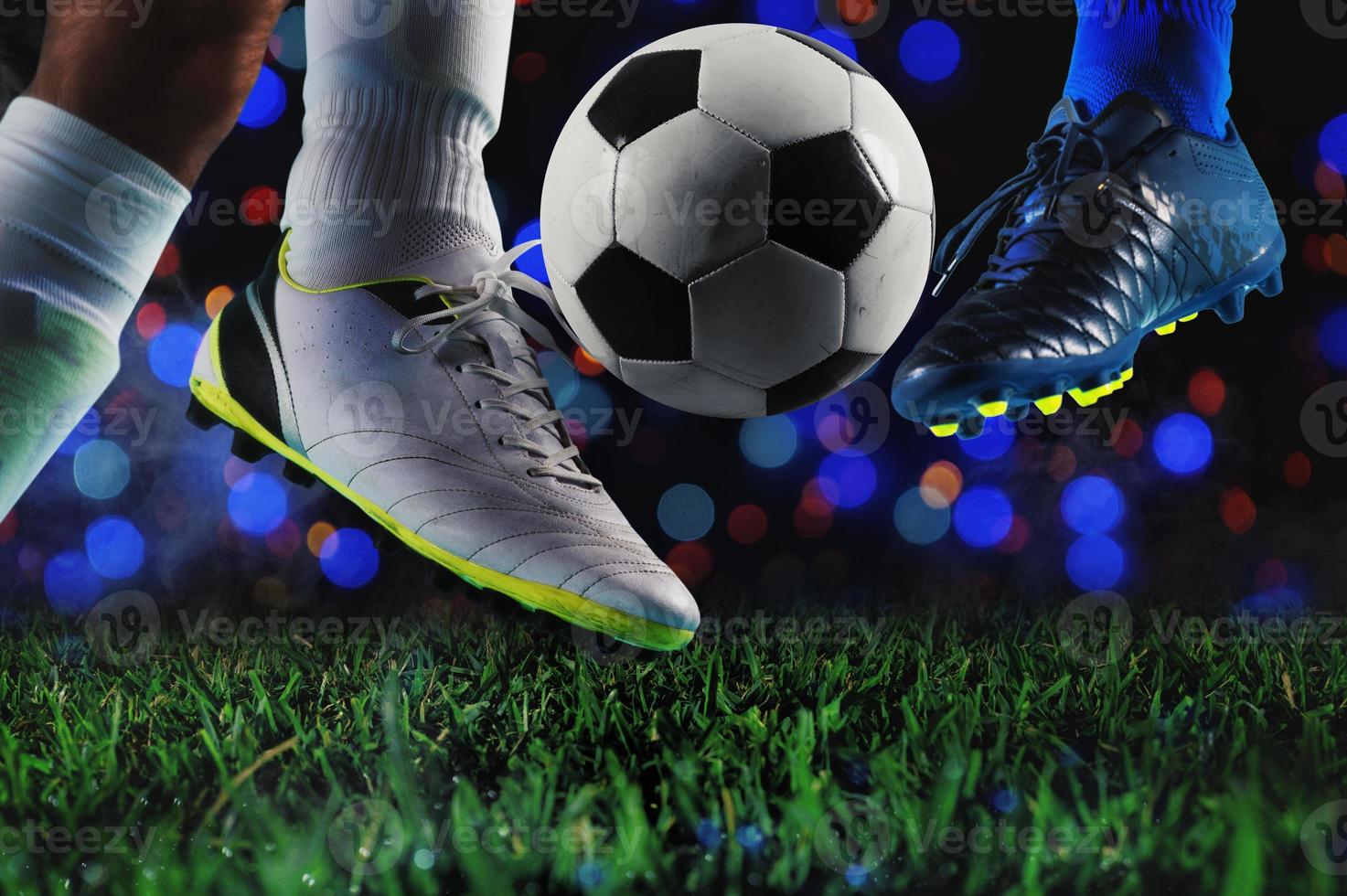 Football players with soccerball at the stadium during the match photo