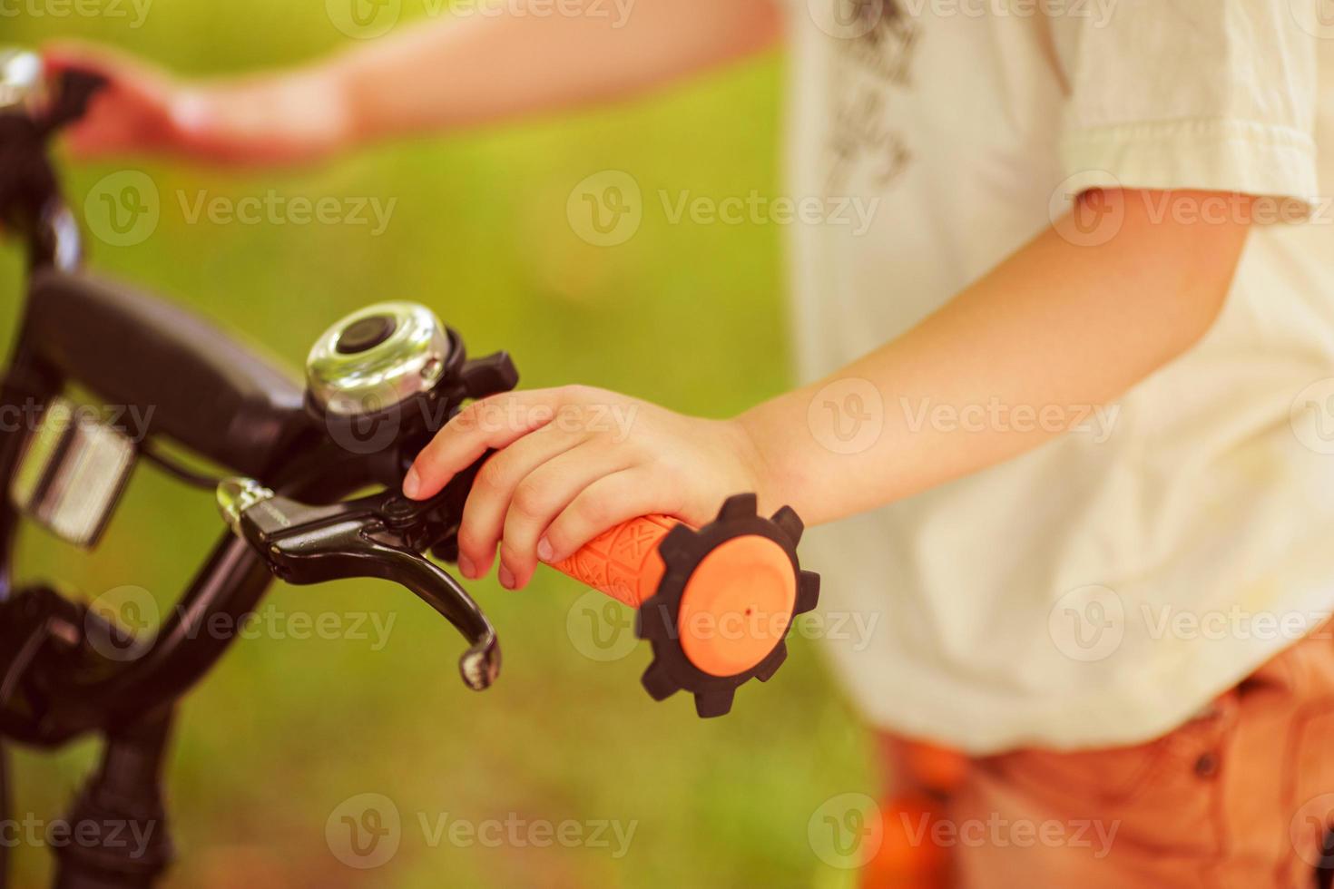 Boy with a bicycle on the street photo