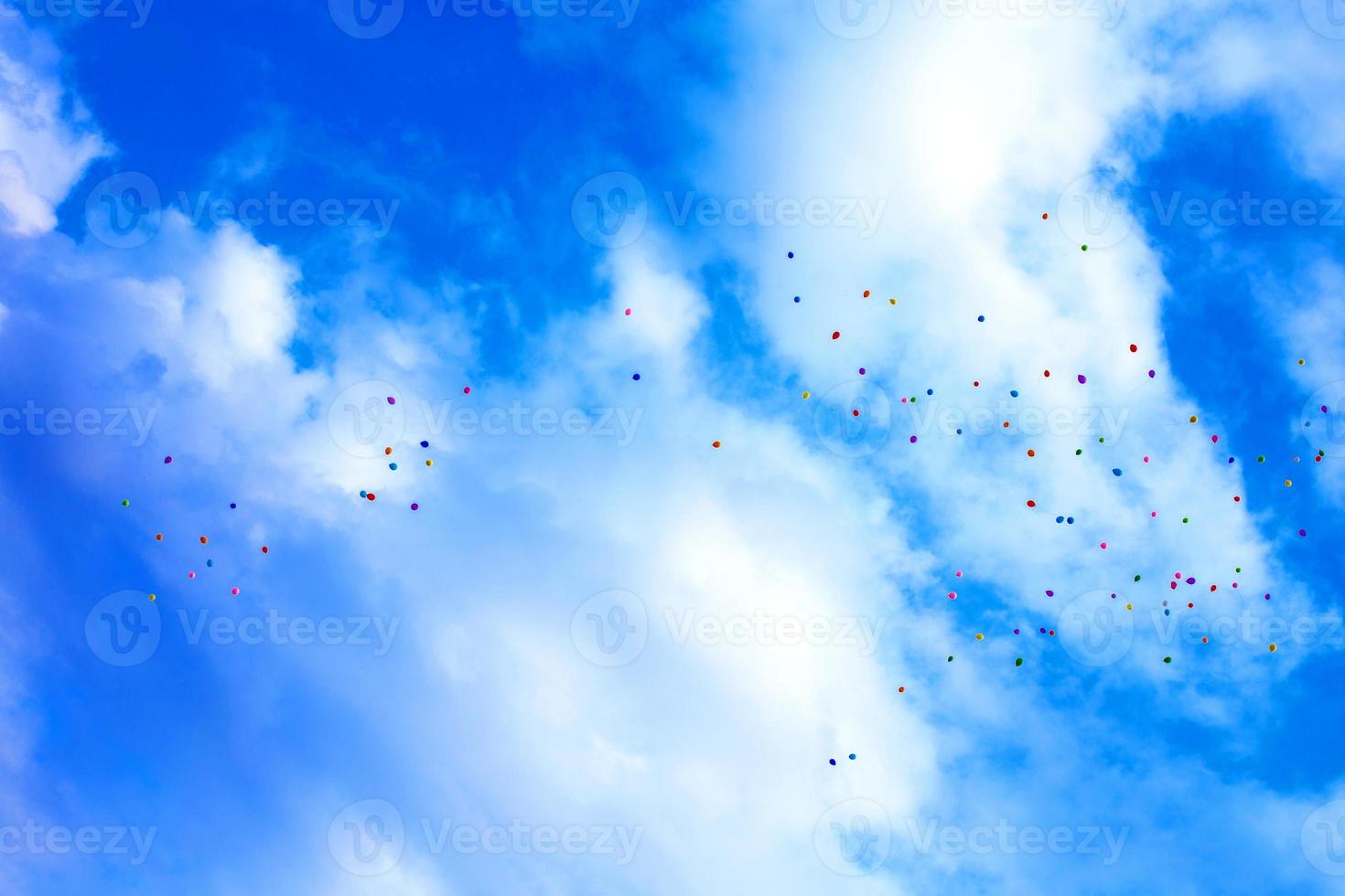 balloons in the sky. many multicolored  balloons launched into the sky photo