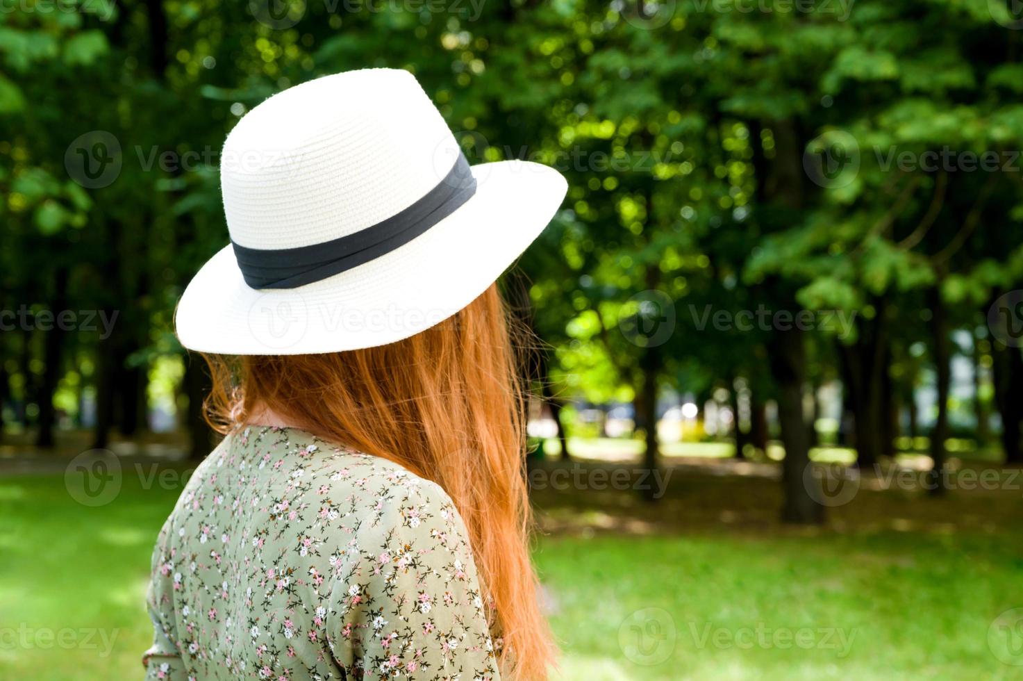 Unrecognizable summer girl relaxing in the park.Banner with place for text. photo