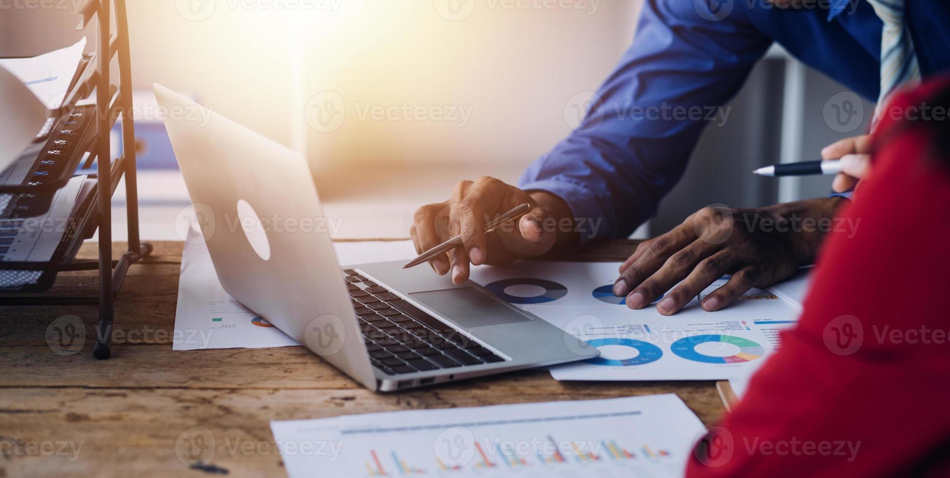 Financial analysts analyze business financial reports on a digital tablet planning investment project during a discussion at a meeting of corporate showing the results of their successful teamwork. photo