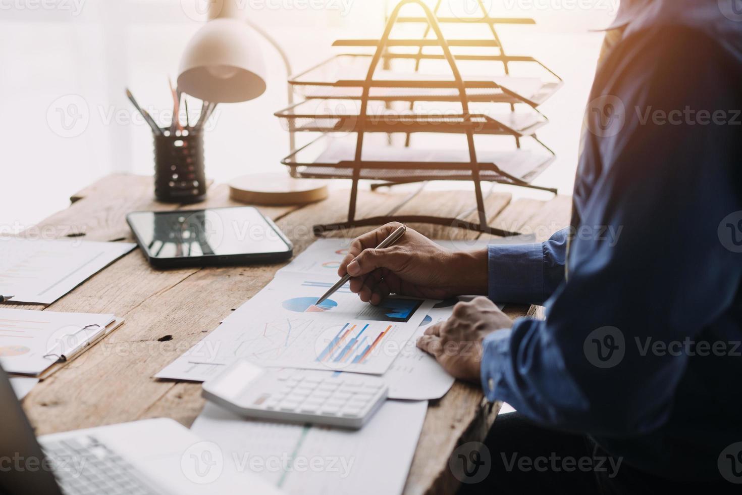 Financial analysts analyze business financial reports on a digital tablet planning investment project during a discussion at a meeting of corporate showing the results of their successful teamwork. photo