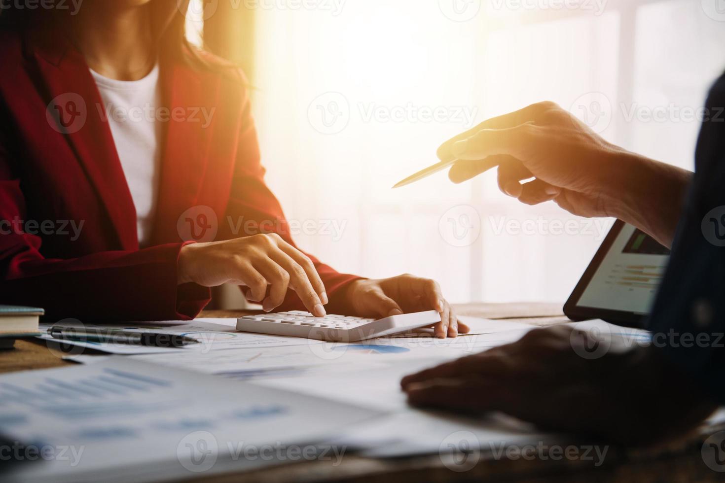 Financial analysts analyze business financial reports on a digital tablet planning investment project during a discussion at a meeting of corporate showing the results of their successful teamwork. photo