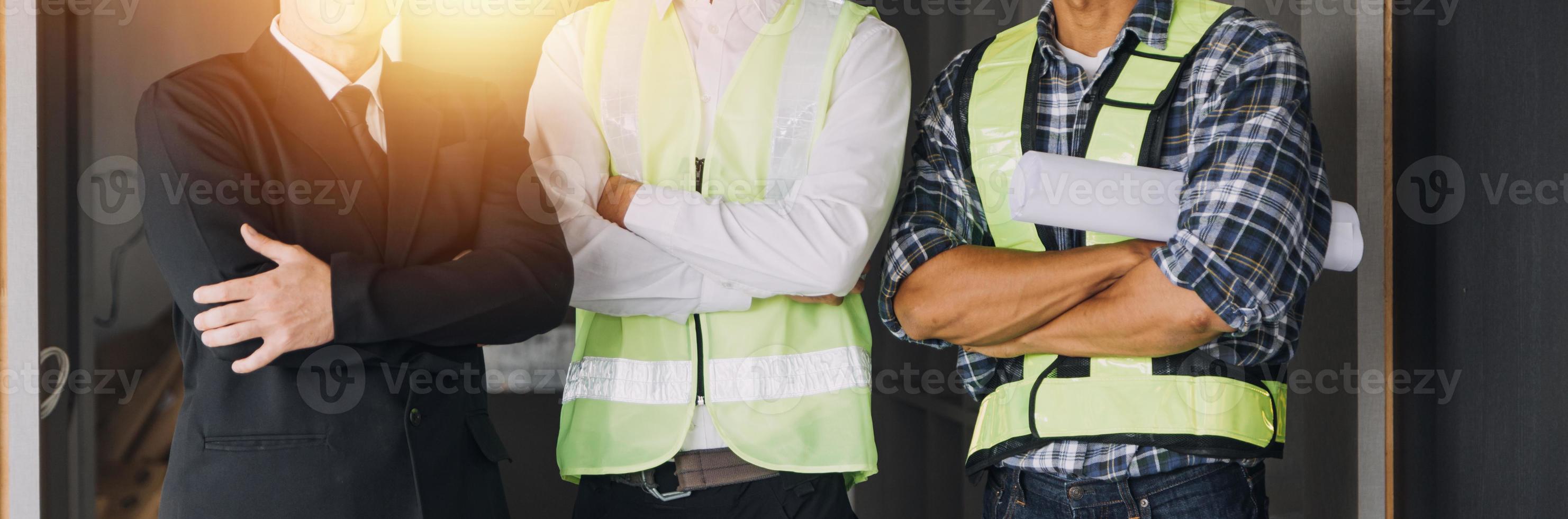 Two business man construction site engineer. Engineering objects on workplace with partners interacting on background photo