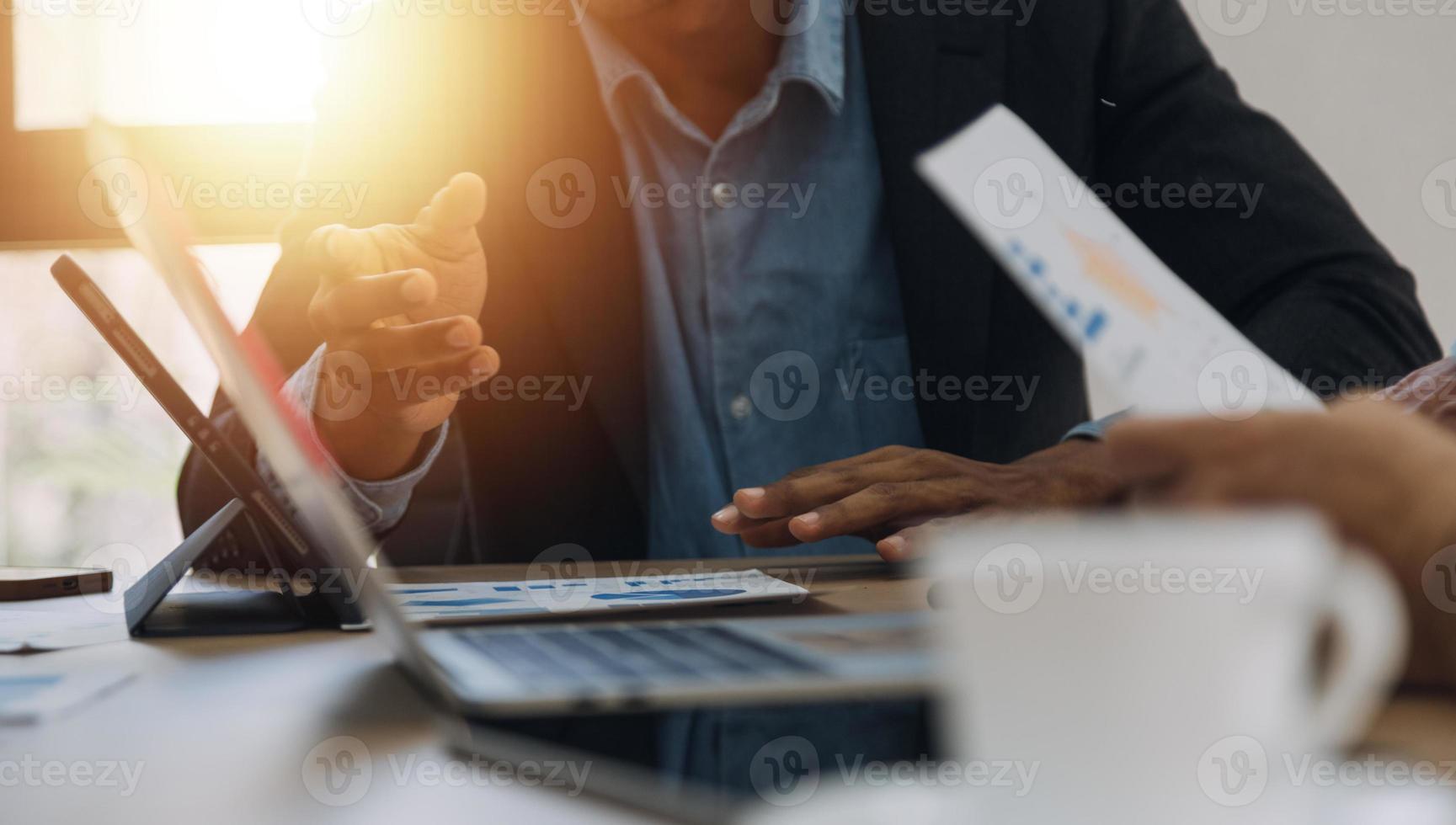 Financial analysts analyze business financial reports on a digital tablet planning investment project during a discussion at a meeting of corporate showing the results of their successful teamwork. photo