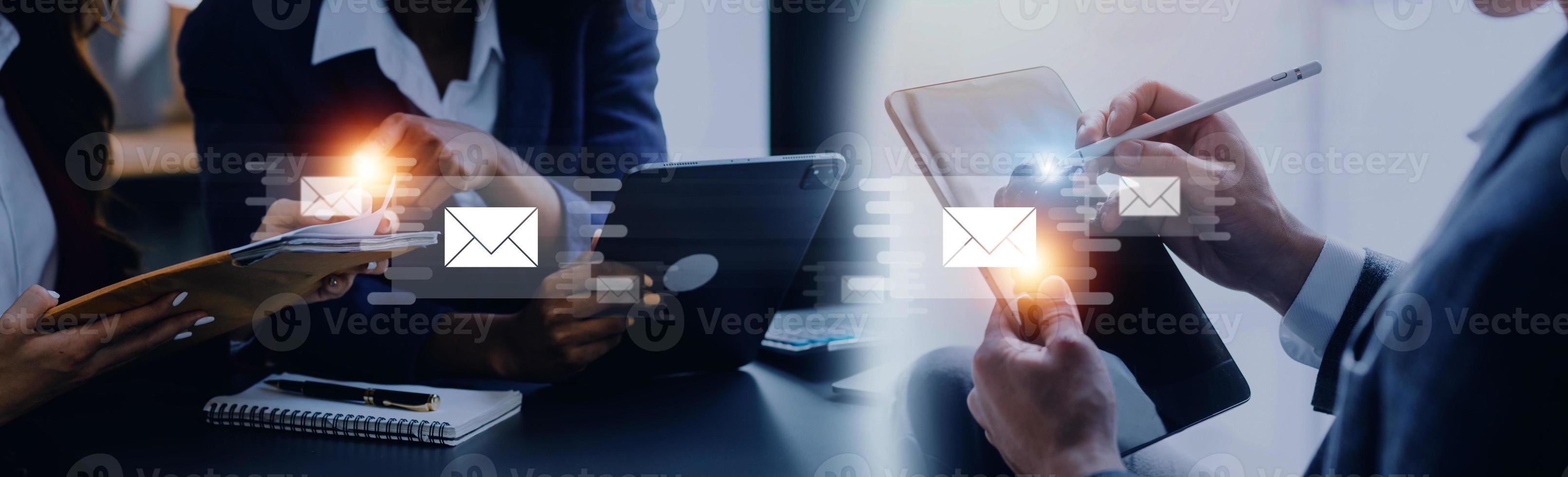 Businessman hands using Laptop typing on keyboard and surfing the internet on office table with email icon, email marketing concept, send e-mail or news letter, online working internet network. photo