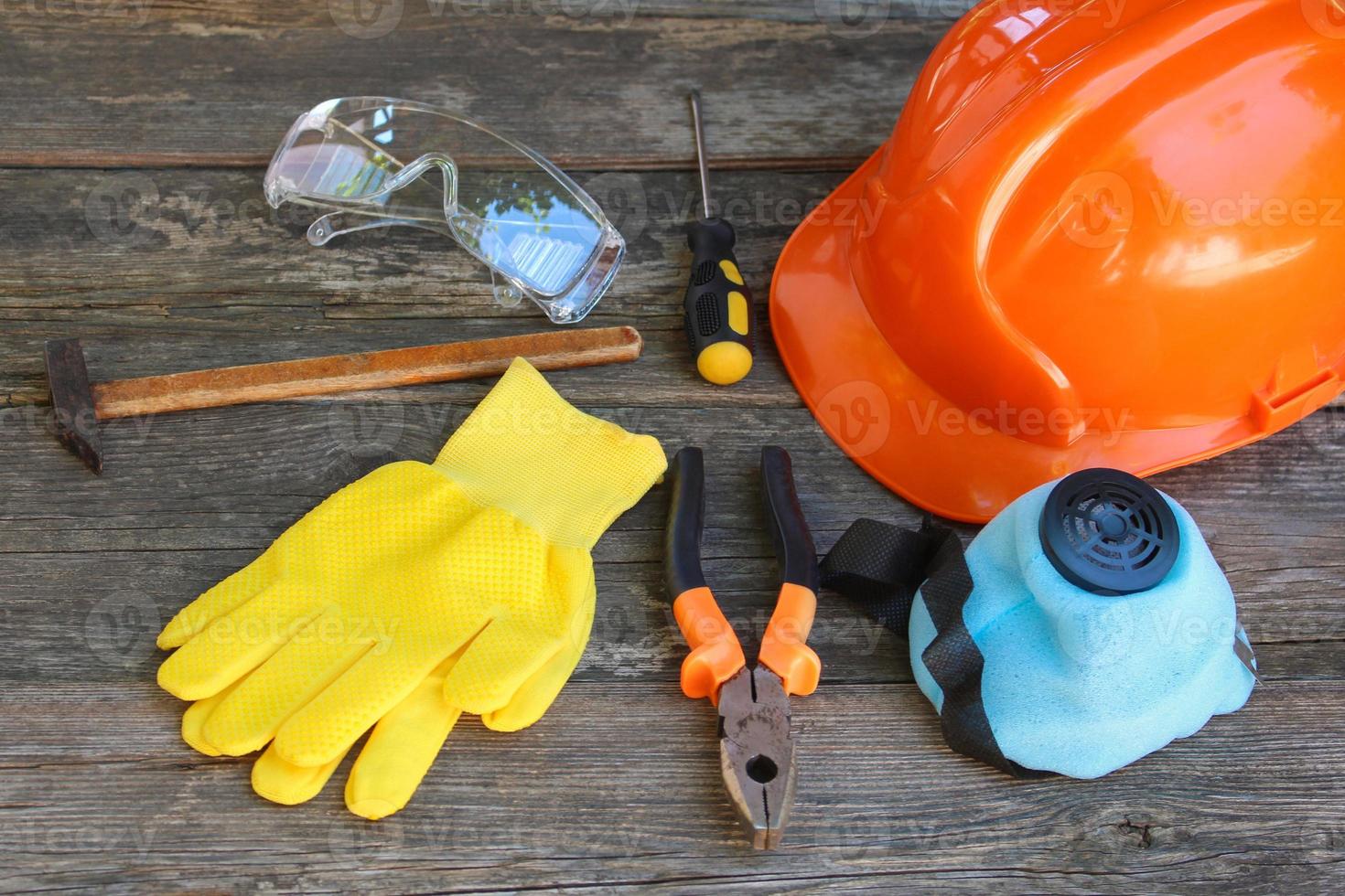 Construction tools and means of protection on an old wooden background. photo