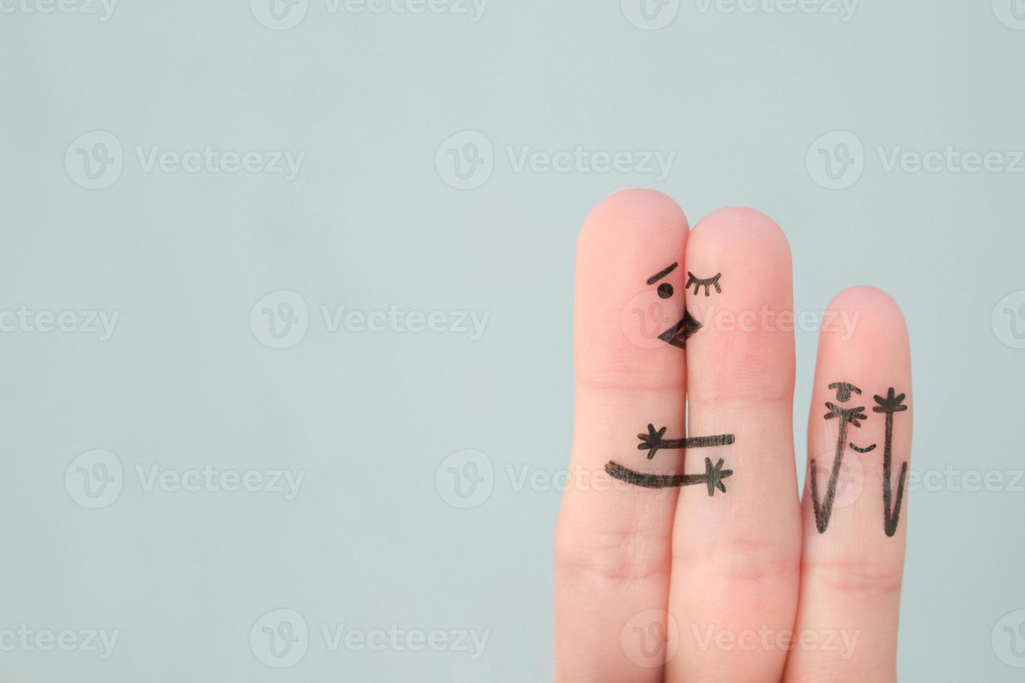 Fingers art of happy family. Concept of couple kisses,  child spies on them. photo