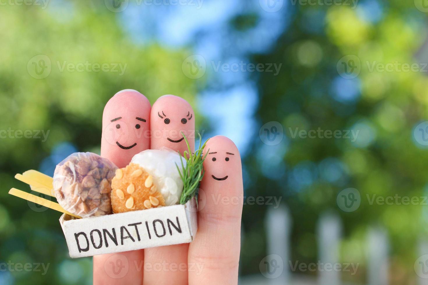 Fingers art of family. Man  and woman holding donation box with food. photo