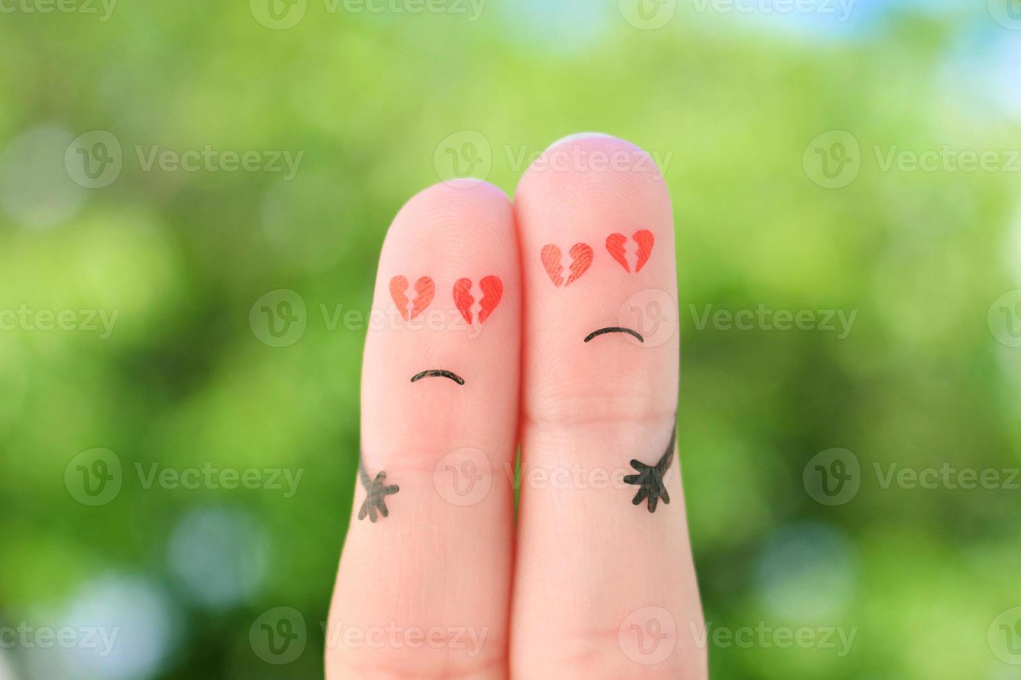 Fingers art of sad couple. Man and woman hug with broken hearts in eyes. photo