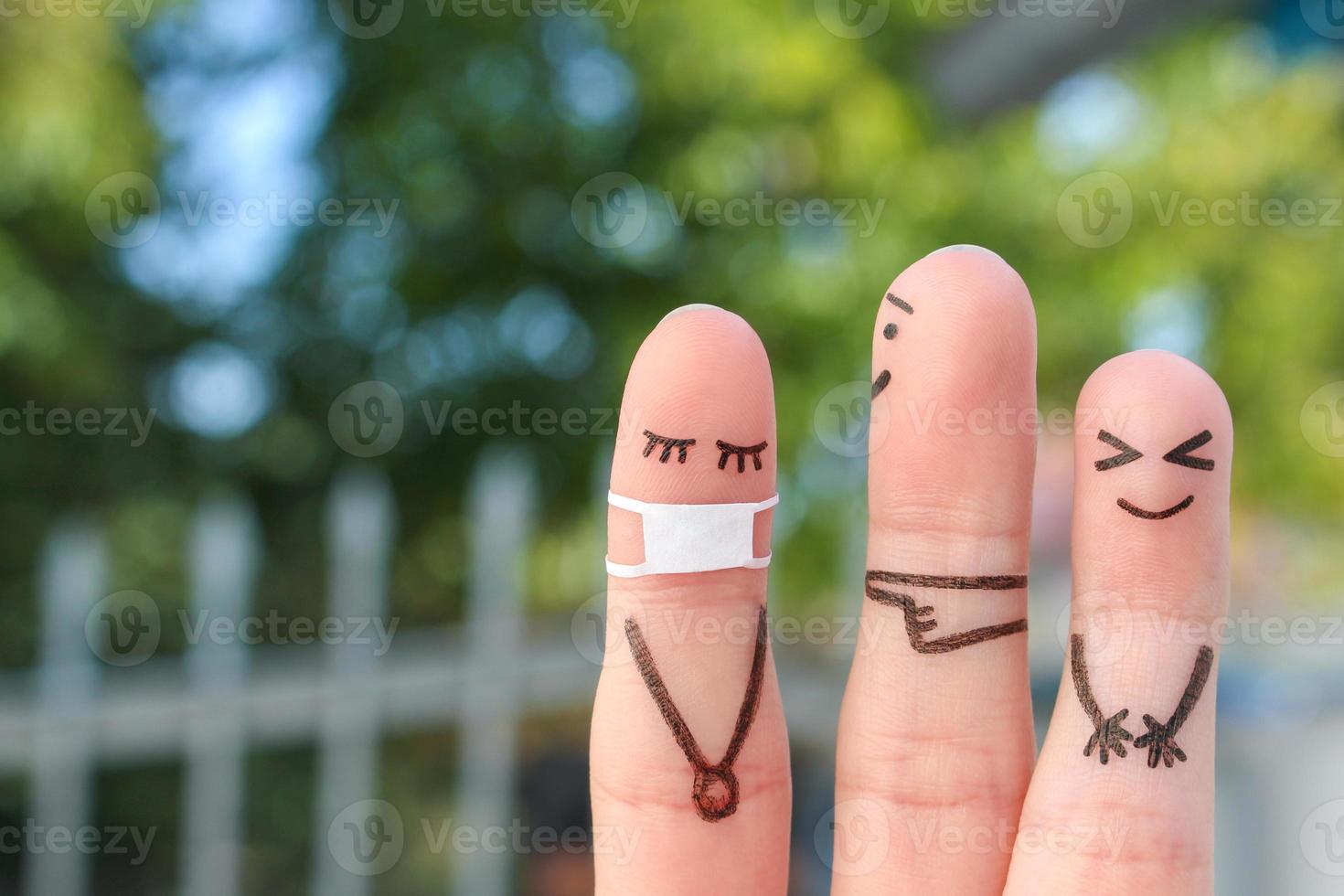 Fingers art of people. Concept children bullying their classmate in medical mask from COVID-2019. photo