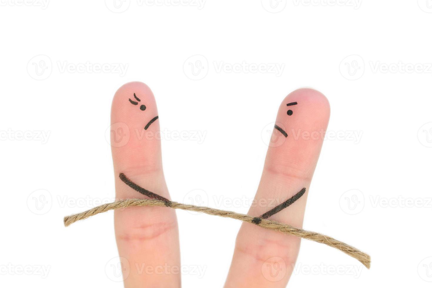 Fingers art of couple. They playing tug of war with rope isolated on white. photo
