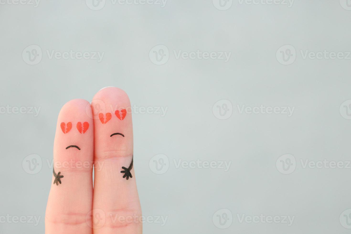 Fingers art of sad couple. Man and woman hug with broken hearts in eyes. photo