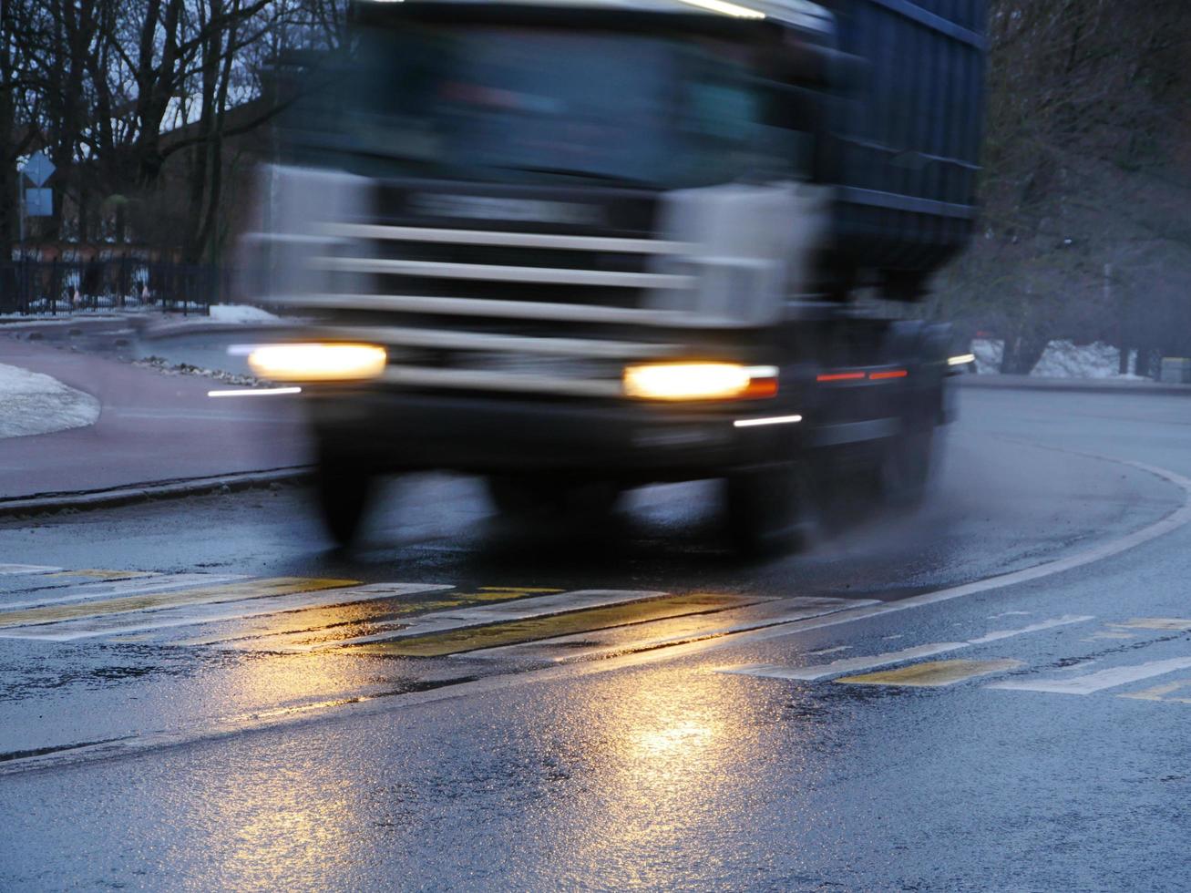 big truck speeding down the road, motion blur front view photo